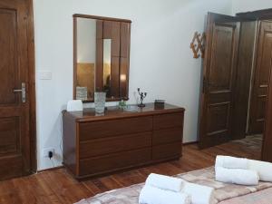 a bedroom with a dresser with a mirror and a bed at I Pelosetti in Calalzo