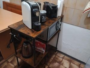 a table with a coffee maker on top of it at I Pelosetti in Calalzo +19 photos