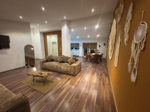 a living room with a couch and a table at BOHO Suite Tierra nähe Salzburg in Freilassing