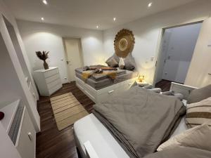 a bedroom with two beds and a mirror on the wall at BOHO Suite Tierra nähe Salzburg in Freilassing
