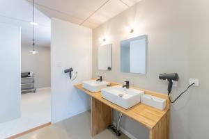 a bathroom with two sinks and a mirror at atic Guesthouse in Takamatsu +29 photos