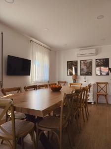 a dining room with a wooden table and chairs at Villa Rosa in Melgaço