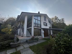 a large white house with a staircase in a yard at Fusero1 relax vero borgata fusero 20 giaveno in Coazze