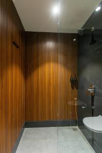 a bathroom with a shower with a sink and a toilet at Assembly By The Democracy in Nashik +37 photos