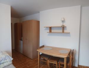 a room with a table and chairs and a bed at Cyklami in Pobierowo