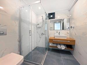 a bathroom with a shower and a sink at Silver Bay Club House in Urla