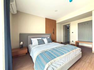 a bedroom with a large bed with two pillows at Silver Bay Club House in Urla