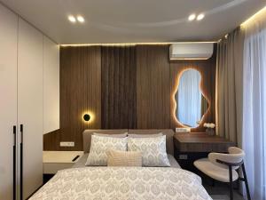 a bedroom with a bed and a desk and a window at RentNow Apartments Luxury Apartment with Balcony and Parking in Chişinău