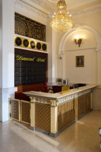 a bar in a lobby with a chandelier at Diamond Hotel in Da Lat