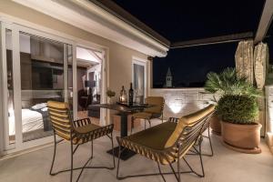 a room with a table and chairs and a bedroom at Murum Heritage Hotel in Split