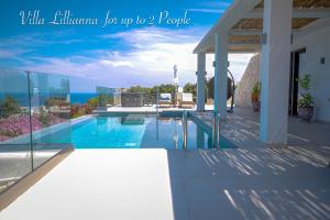 a house with a swimming pool with a view of the ocean at Villa Lamar Private Luxury Villa in Marathias