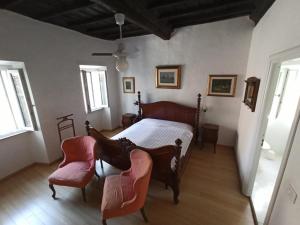 a bedroom with a bed and two chairs at Zen and Breakfast in Veiano +12 photos