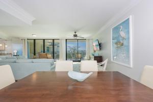 a dining room with a table and a living room at Phoenix on the Bay 1320 in Orange Beach