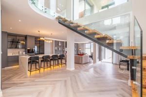 a kitchen and dining room with a staircase in a house at Pinnacle Villa in Plettenberg Bay