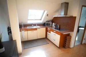 a small kitchen with a sink and a microwave at Le Bollwiller Piscine Jacuzzi Vignoble in Bollwiller +19 photos