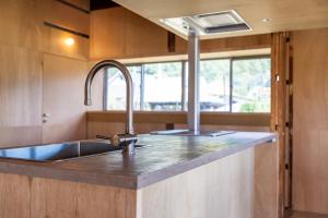a kitchen with a stainless steel sink and a window at ICHI -en- in Fujikawaguchiko