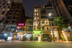 a city street at night with tall buildings at Catinal Hotel in Danang