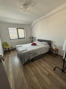 a bedroom with a bed and a window at SkyView Lofts-Enjoy the view in Preajba