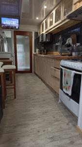a kitchen with a stove and a counter top at Hostal Don Francisco in Osorno