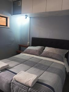 a bedroom with a large bed with two pillows at Hostal Don Francisco in Osorno