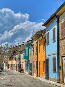 a row of colorful buildings on a street at Lo Squero Guest House in Fano