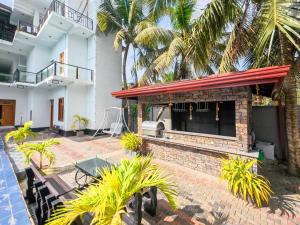 a resort with a bar and palm trees at Omar Villa in Bentota