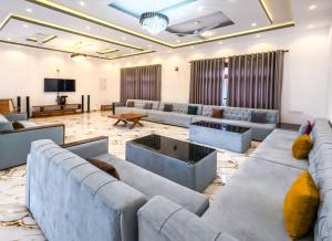 a large living room with couches and a tv at Omar Villa in Bentota