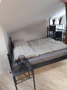 a bed in a room with a chair next to it at Boxenstop in Kleinlobming