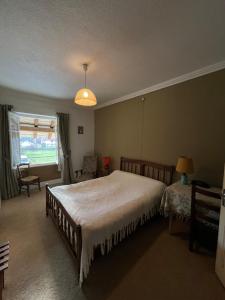 a bedroom with a large bed and a window at Ancien hotel Bourgeois in Andelot-en-Montagne