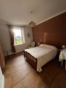 a bedroom with a large bed and a window at Ancien hotel Bourgeois in Andelot-en-Montagne +3 photos
