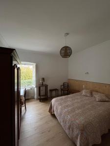 a bedroom with a large bed and a window at Ancien hotel Bourgeois in Andelot-en-Montagne