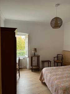 a bedroom with a bed and a window at Ancien hotel Bourgeois in Andelot-en-Montagne