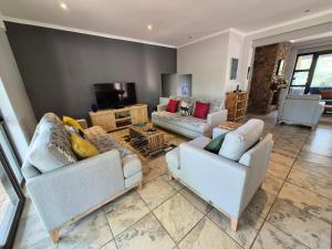 a living room with two couches and a television at Brett's Place in Warmbaths +71 photos