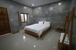 a bedroom with a bed and a window in it at Krabi Aonang happy resort in Ao Nam Mao