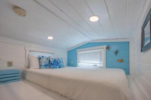a bedroom with a large bed with a blue wall at Matlacha Tiny Village in Matlacha