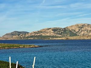 a large body of water with mountains in the background at Residenza Ponente in Stintino