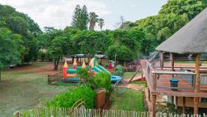 a playground with a water slide in a park at Falcon Lodge (S) in Bela-Bela