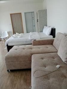a living room with a couch and a bed at เดอะโดมโฮมสเตย์ ม่อนแจ่ม in Mon Jam +2 photos