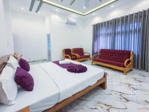a bedroom with a large bed and a couch at Omar Villa in Bentota +67 photos