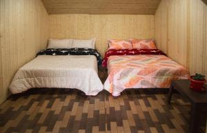 a room with two beds in a small room at Open view home stay in Mangpu