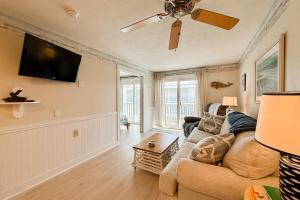 a living room with a couch and a ceiling fan at Saltwater Breeze in Wells