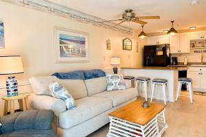 a living room with a couch and a table at Saltwater Breeze in Wells