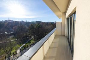 a balcony with a view of the city at Hotel Allegra in Prishtinë