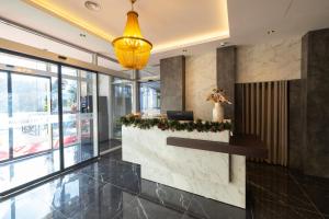 a lobby with a reception desk in a building at Hotel Allegra in Prishtinë