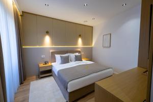a bedroom with a large bed with lights on it at Hotel Allegra in Prishtinë +38 photos
