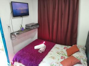 a room with a bed with a candle on it at Elvira's natural lodge in Burzaco