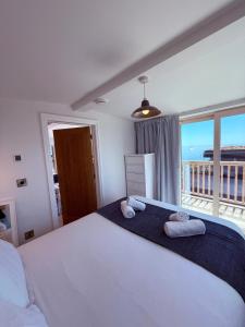 a bedroom with a large bed with towels on it at Recently renovated beach shack with a view in Antony
