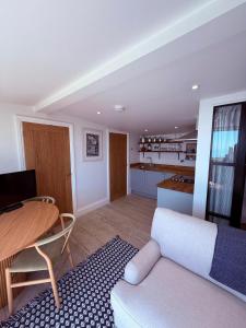 a living room with a table and a couch at Recently renovated beach shack with a view in Antony +15 photos