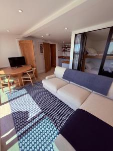 a living room with a couch and a table at Recently renovated beach shack with a view in Antony
