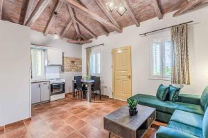 a living room with a couch and a table at Villa Palataki II in Kardamyli